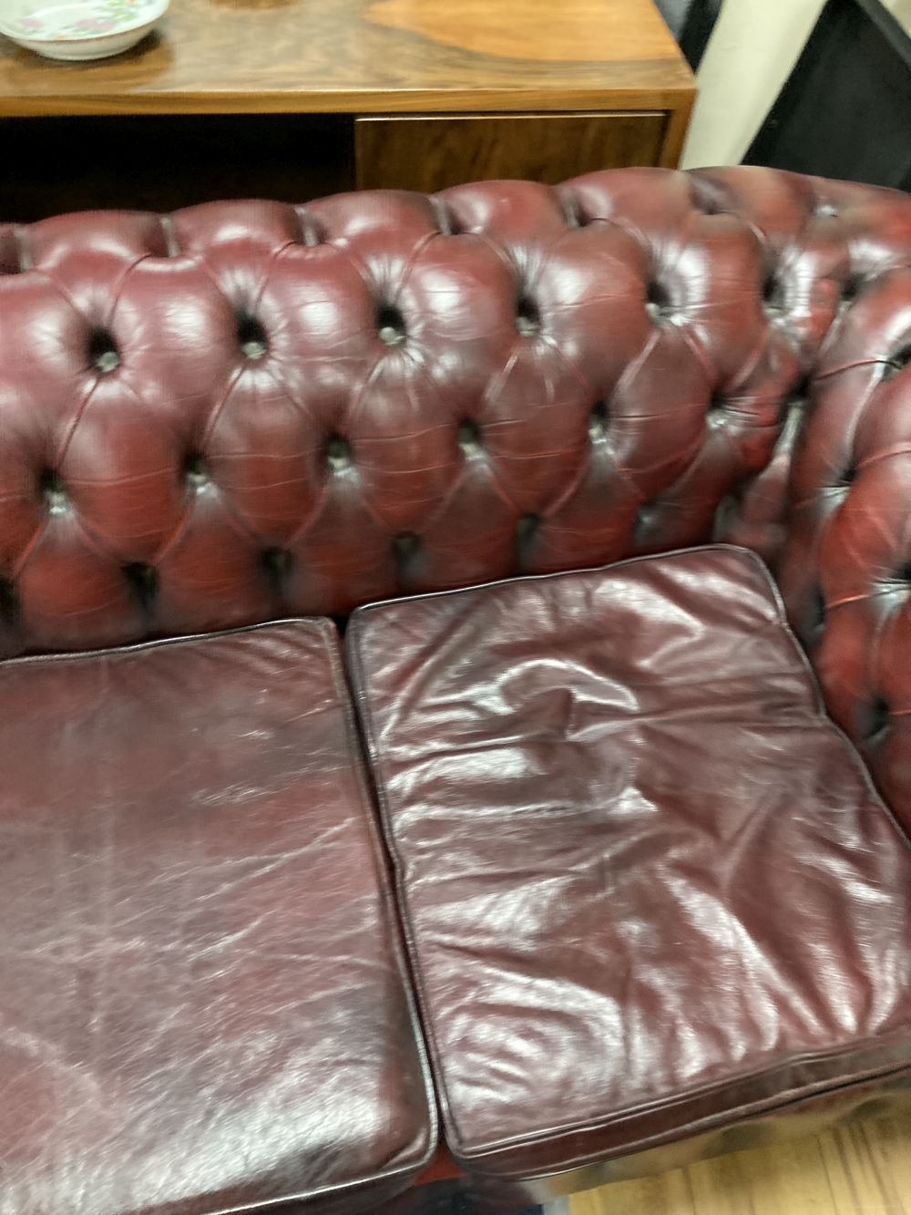 A Victorian style buttoned burgundy leather three seater Chesterfield settee, width 190cm depth 85cm height 72cm